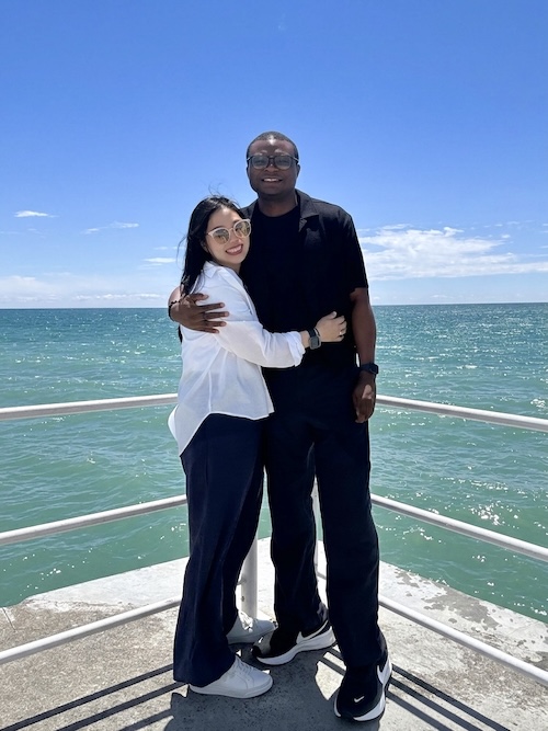 Jessi and Seyi hugging on a pier